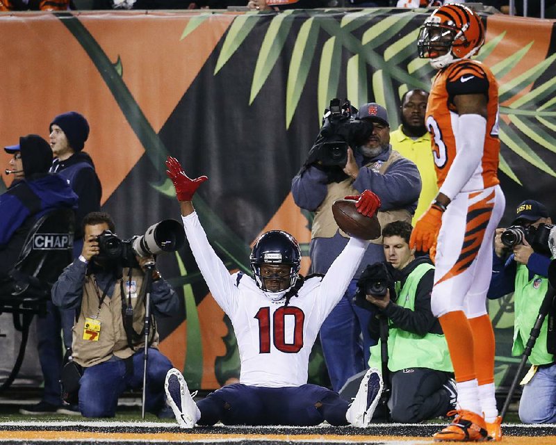 Houston Texans wide receiver DeAndre Hopkins (10) celebrates after scoring a touchdown in front of Cincinnati Bengals strong safety George Iloka during the fourth quarter of Monday’s game in Cincinnati. Hopkins’ 22-yard score was the only touchdown in the game.
