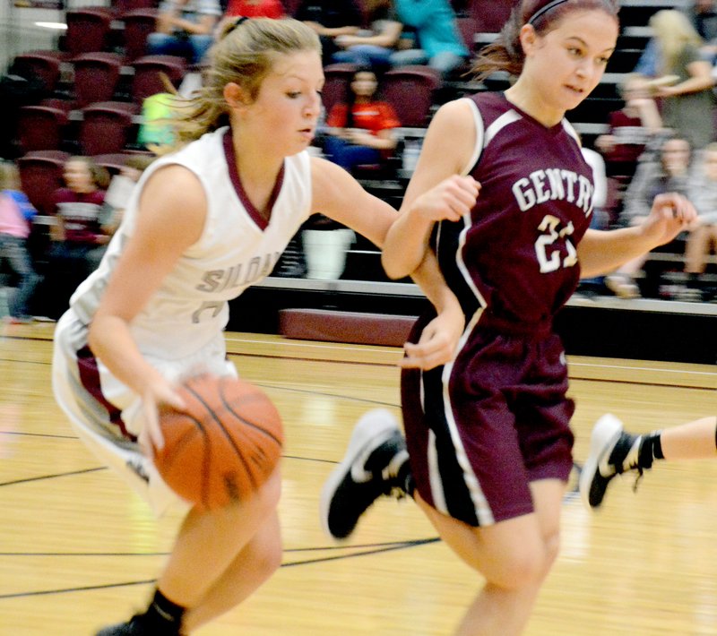Siloam Springs’ Alexis Roach tries to get by Gentry defender Madison Ward during Monday’s game at the 29th annual Allen Classic.
