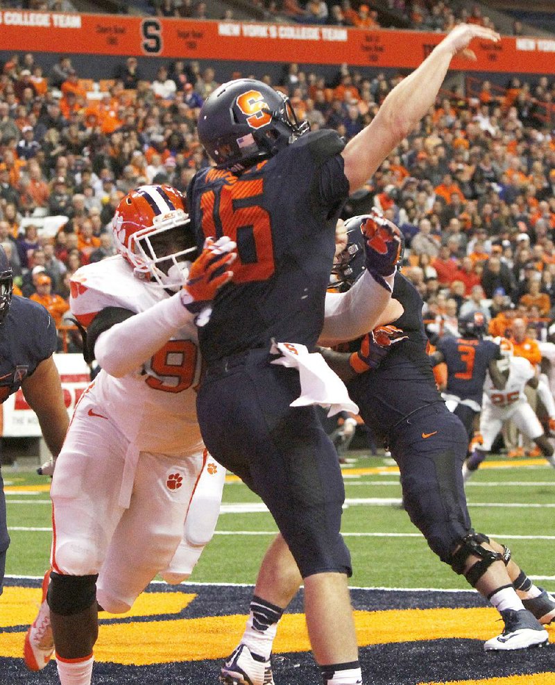 Clemson held off Syracuse 37-27 at the Carrier Dome in Syracuse, N.Y., last Saturday and held onto to the No. 1 ranking when the third College Football Playoff poll was released Tuesday. The Tigers struggled, but survived with help from Shaq Lawson (above), who kept the pressure on Syracuse quarterback Zach Mahoney.