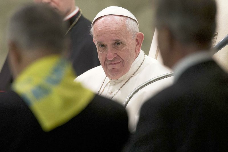 Pope Francis listens to a speech during an audience with members of the Don Guanella charity organization, in the Pope Paul VI hall, at the Vatican, Thursday, Nov. 12, 2015.