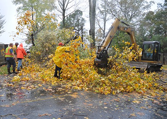 The Sentinel-Record/Mara Kuhn Garland County Road Department workers clear fallen trees and debris in the 400 block of Lake Hamilton Drive after a severe thunderstorm swept through the area Tuesday.