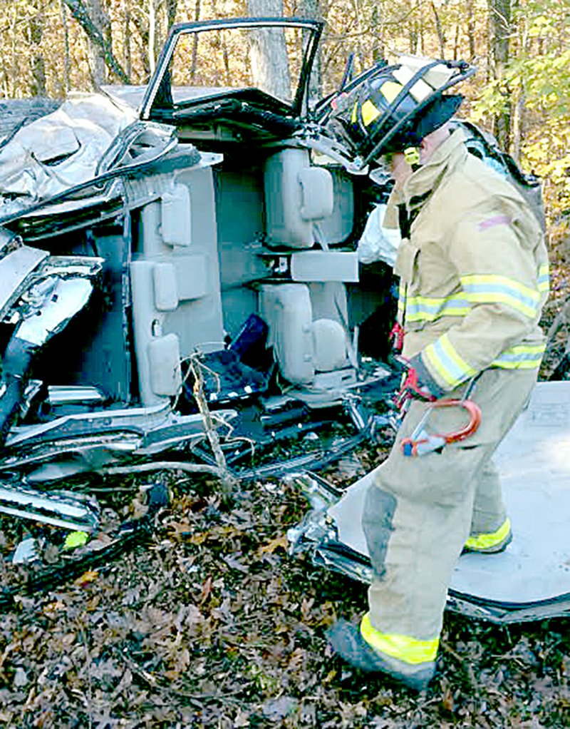 Courtesy of Lucky Koucky at the Bella Vista Fire Department A firefighter with the Bella Vista Fire Department surveys the scene of single-vehicle accident Nov. 6 on Arkansas 340 near Bedlington Lane. The Driver, Christina Cassidy of Garfield, ran off the road after leaving Ozark Beverage Co. early in the morning. Cassidy, who was conscious and talking at the scene, had to be extricated from the vehicle, according to a Bella Vista Police incident report. Cassidy was charged with driving while intoxicated, refusal to submit and careless/prohibited driving.