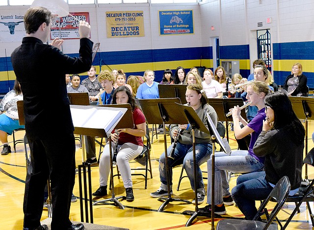 Photo by Mike Eckels Jesse Owens, Decatur&#8217;s band and choir director, conducts the Decatur High School band in a medley of familiar John Phillip Sousa marches, including Stars and Strips Forever, during the Decatur High School Veterans Day assembly at Peterson Gym on Nov. 11.