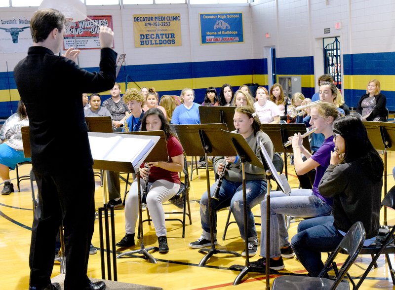 Photo by Mike Eckels Jesse Owens, Decatur&#8217;s band and choir director, conducts the Decatur High School band in a medley of familiar John Phillip Sousa marches, including Stars and Strips Forever, during the Decatur High School Veterans Day assembly at Peterson Gym on Nov. 11.