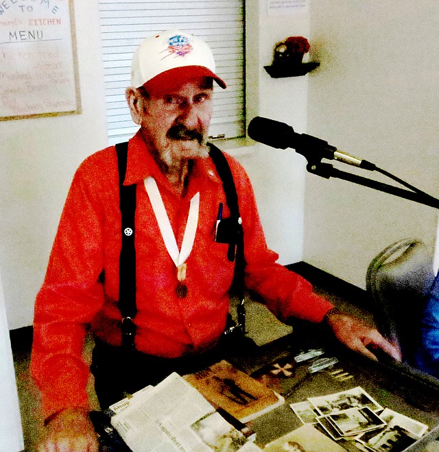 Photo by Susan Holland Gomer Alsup, 92, of Gravette, was guest speaker at the Veterans Day program Tuesday, Nov. 10, at the Billy V. Hall Senior Activity Center. Alsup told his audience about his experiences during World War II, fighting in the Philippines and his last assignment in Japan. Alsup displayed pictures he took during the war and brought his medals, his Army manual and the small sewing kit the Red Cross provided each soldier.