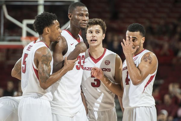 Arkansas players (left to right) Anthlon Bell, Moses Kingsley, Dusty Hannahs and Jabril Durham talk during the Razorbacks' game against Southern on Friday, Nov. 13, 2015, at Bud Walton Arena.