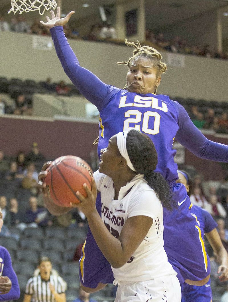 UALR’s Shanity James (bottom) tries to go up for a shot as LSU’s Alexis Hyder defends during Wednesday night’s game at the Jack Stephens Center in Little Rock.