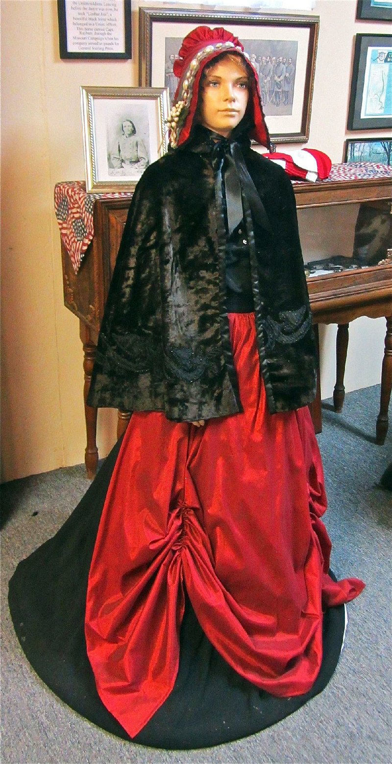 At Lonoke County Museum, a mannequin dressed in ballroom attire represents a Confederate guerrilla disguised as a young woman to infiltrate a Union dance. 