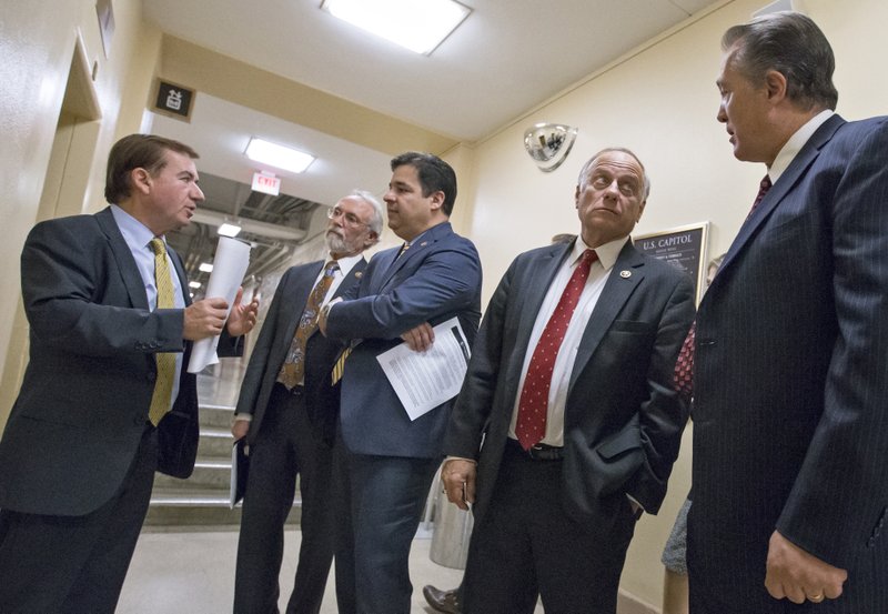 From left, House Foreign Affairs Committee Chairman Rep. Ed Royce, R-Calif., Rep. Dan Newhouse R-Wash., Rep. Raul Labrador, R-Idaho, Rep. Steve King, R-Iowa, and Rep. Trent Franks, R-Ariz., confer on Capitol Hill in Washington, Wednesday, Nov. 18, 2015, following a meeting of the conservative Republican Study Committee ahead of legislation aimed at increasing screenings for Syrian and Iraqi refugees before they enter the U.S., including a requirement for FBI background checks.  