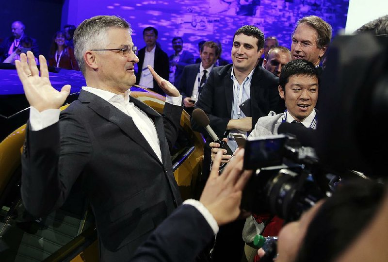 Michael Horn (left), president and chief executive of Volkswagen Group of America, talks to reporters at the Los Angeles Auto Show on Wednesday.