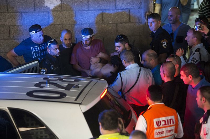 Israeli police arrest a Palestinian identified as Raed Khalil bin Mahmoud after a fatal stabbing attack at an office building Thursday in Tel Aviv. 