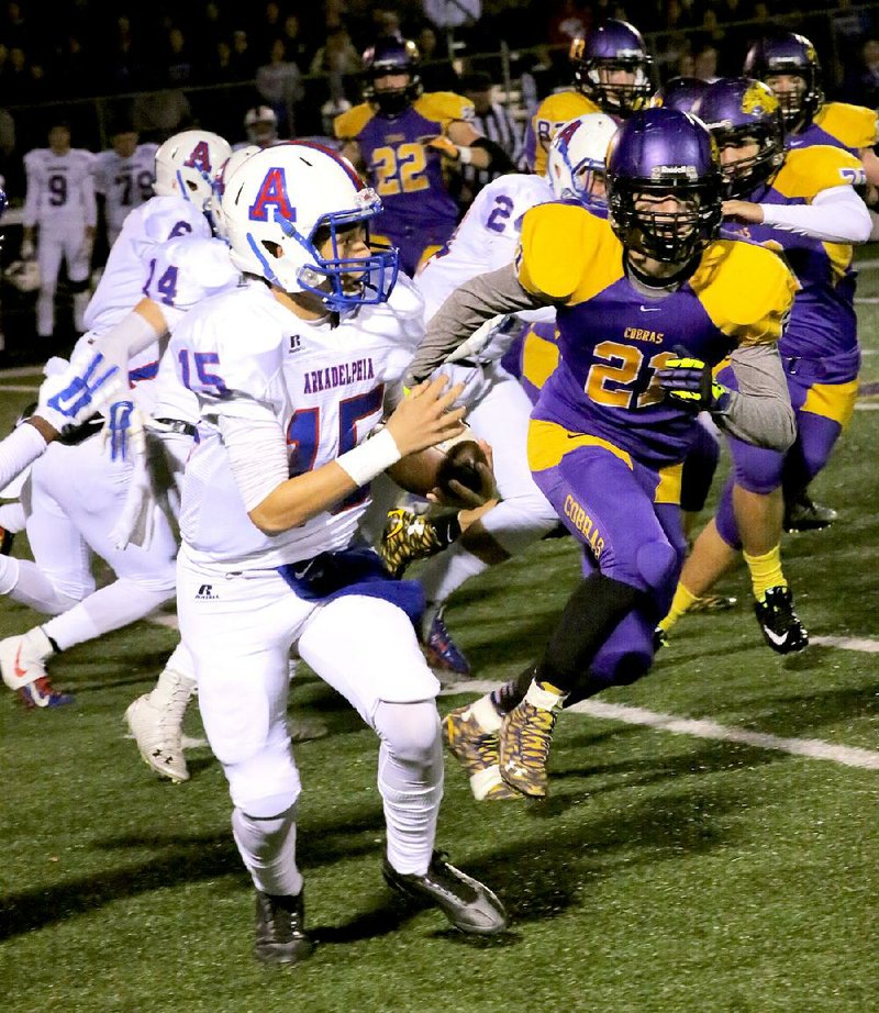 Arkadelphia’s Logan Lucas (15) runs past Fountain Lake’s Dillon Horton during the second round of the Class 4A state playoffs Friday. Lucas and the Badgers held on for a 19-14 victory.