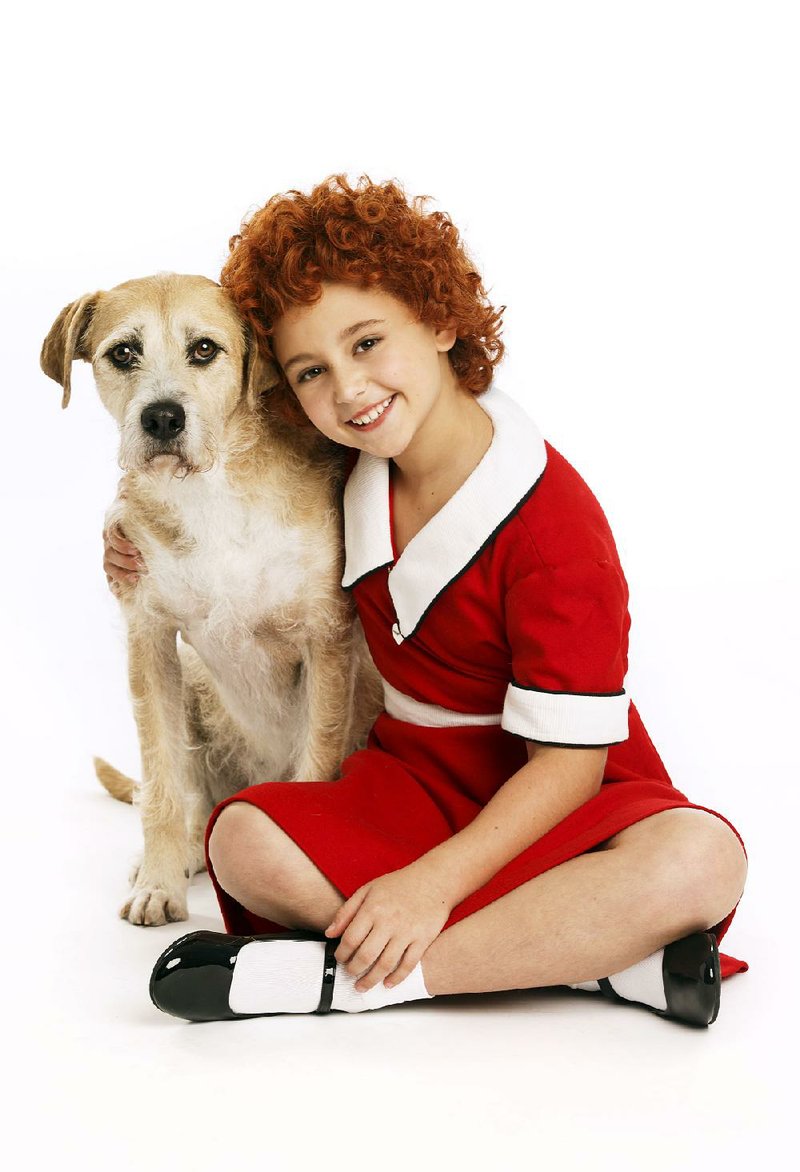 Issie Swickle plays orphan Annie with Sunny as her dog, Sandy, in the national tour of Annie, on stage this week at Fayetteville’s Walton Arts Center.
