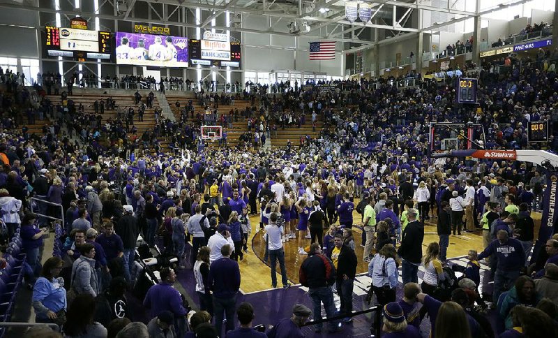 Northern Iowa fans rush the court Saturday after the Panthers beat No. 1 North Carolina 71-67 in Cedar Falls, Iowa. 