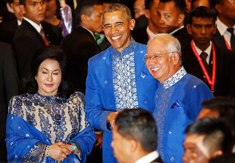 President Barack Obama poses for pictures Saturday in Kuala Lumpur with Malaysian Prime Minister Najib Razak and his wife, Rosmah Mansor, before a gala dinner for a gathering of the 10-nation Association of Southeast Asian Nations.
