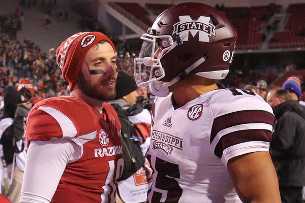 Arkansas' Brandon Allen chats with Mississippi State's Dak Prescott after their game Saturday, Nov. 21, 2015, in Fayetteville.