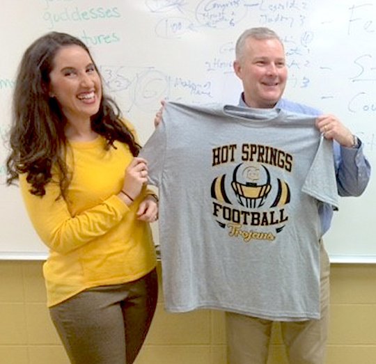 Submitted photo Social Studies teacher Meredith Armstrong, left, presented Lt. Gov. Tim Griffin with a Trojans football shirt during a visit to Hot Springs Intermediate School on Oct. 27. The shirt was presented to Griffin as a gesture of the school's appreciation of his service. Armstrong declared him an "honorary Trojan."