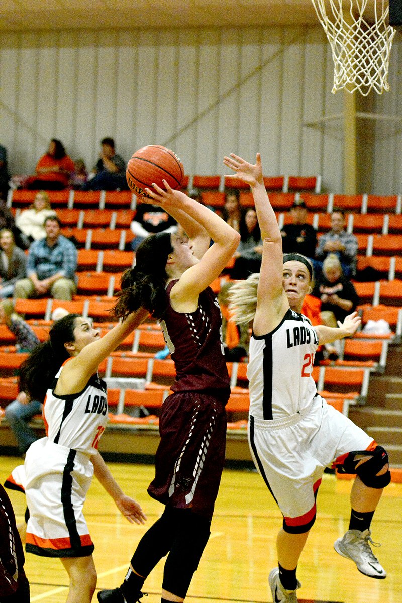 Bud Sullins/Special to Siloam Sunday Siloam Springs sophomore Hadlee Hollenback goes up with the shot as Gravette&#8217;s Kayla Kardynalski defends Thursday in the Lady Panthers&#8217; season-opening 63-38 win at Lion Gymnasium. Hollenback scored 17 points for Siloam Springs in the victory.