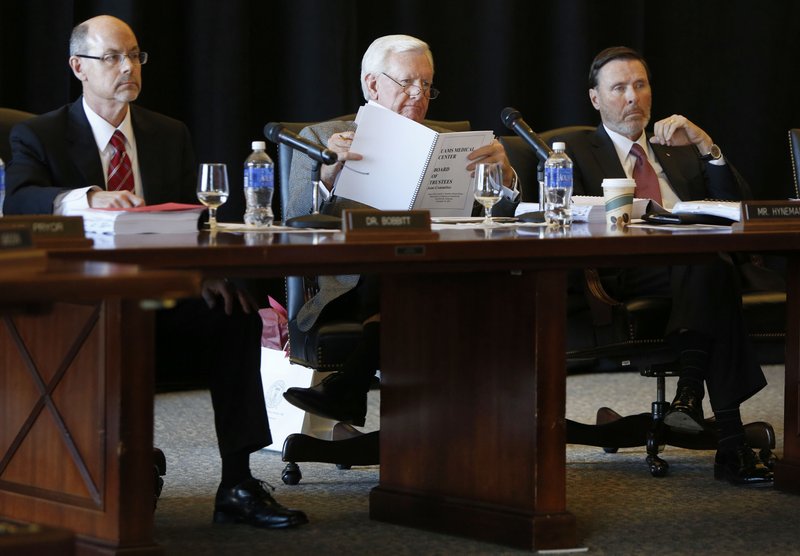 Donald Bobbitt (from left), president of the University of Arkansas System, Ben Hyneman, chairman, and Reynie Rutledge, vice chairman, listen Thursday during the University of Arkansas System Board of Trustees meeting at the Janelle Y. Hembree Alumni House on campus in Fayetteville.