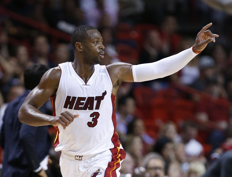 Miami Heat guard Dwyane Wade celebrates after scoring during the first half of an NBA basketball game against the Philadelphia 76ers, Saturday, Nov. 21, 2015, in Miami. 