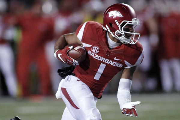 Arkansas' Jared Cornelius runs the ball during the second half of an NCAA college football game against Mississippi State, Saturday, Nov. 21, 2015 in Fayetteville, Ark. Mississippi State won 51-50. (AP Photo/Samantha Baker)