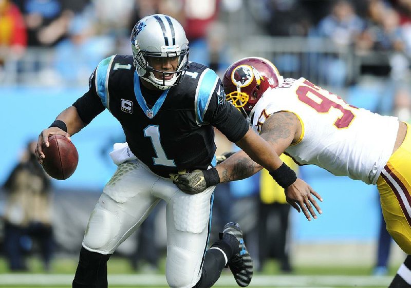 Carolina Panthers quarterback Cam Newton (1) scrambles out of the pocket under pressure from Washington Redskins defensive end Jason Hatcher duringthe fi rst half Sunday in Charlotte, N.C. Newton threw for 246 yards and 5 touchdowns in a 44-16 rout.