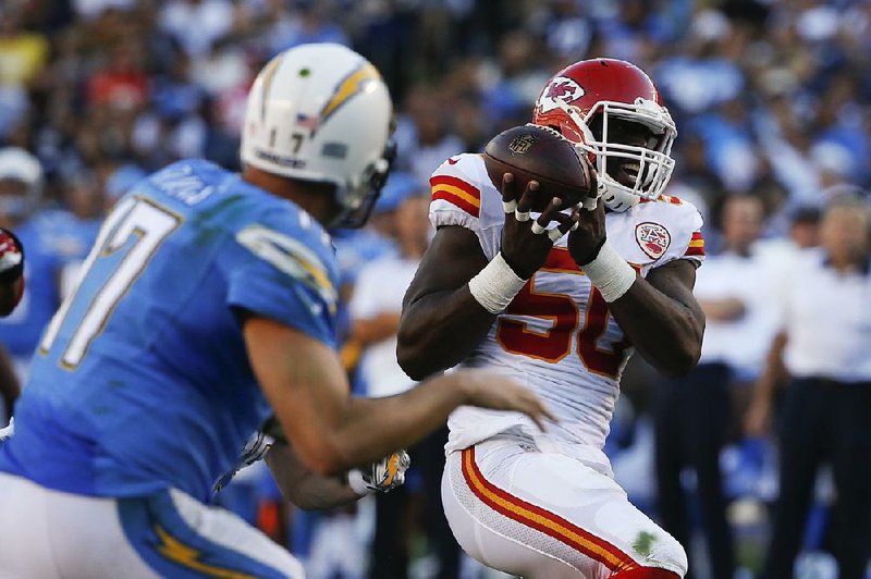 Kansas City Chiefs linebacker Justin Houston (50) intercepts a pass from San Diego Chargers quarterback Philip Rivers during the second half Sunday. Houston returned the interception for 17-yard touchdown.
