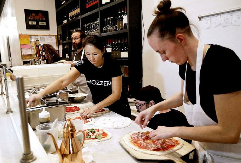 Mozzeria owner Melody Stein (left) and Sabrina Ferguson make pizzas at the restaurant in San Francisco earlier this month.
