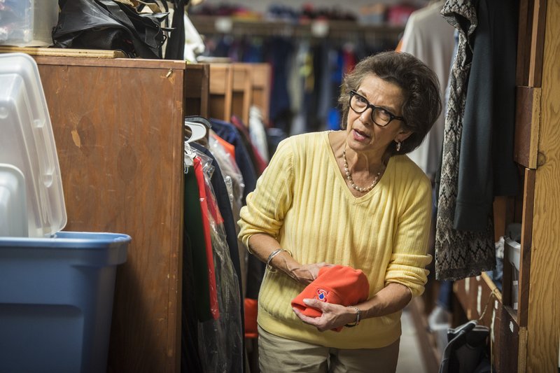 Beverly Charleton, social services for Springdale School District, sorts through winter hats Tuesday at a storage area for clothes, food and school supplies for the district. The NWA Community Christmas Card campaign is starting, which will help raise money for area school districts, including Springdale. For more photos, go to www.nwadg.com/photos.