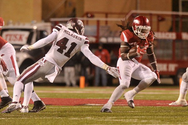 Arkansas defensive lineman McTelvin Agim gets ready to run a play against  Mississippi State during an NCAA college football game, Saturday, Nov. 2,  2019 in Fayetteville, Ark. (AP Photo/Michael Woods Stock Photo 