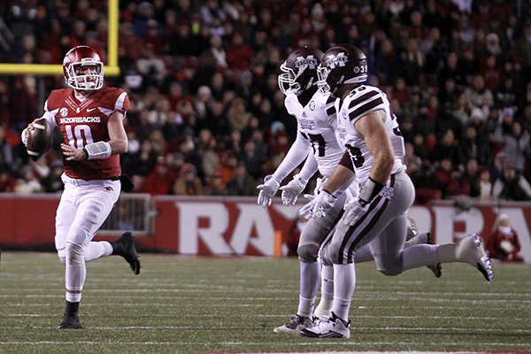 Arkansas' Brandon Allen (10) makes a pass attempt while on the run during the first half of an NCAA college football game against Mississippi State, Saturday, Nov. 21, 2015 in Fayetteville, Ark. Mississippi State beat Arkansas, 51-50. (AP Photo/Samantha Baker)