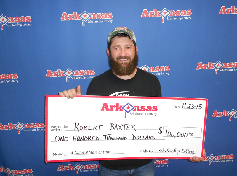 Robert Baxter poses with his check for $100,000. 