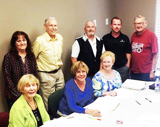 Submitted photo GOOD WORKS: Village Employee Benefit Fund Board members prepare for the 2015 campaign. Seated are, from left, Marlys Moodie-Dodson, Chris Cash and Susan Veal, with Terry Sloan, Bob Smith, Bill Brusenhan, Ryan Bartholomew and Gene Lichliter standing. The program was created to offer thanks to Hot Springs Village POA employees, and donations are now being accepted.