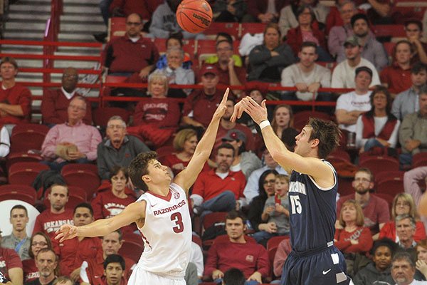 Akron's Jake Ketzer shoots over Arkansas' Dusty Hannahs during a game Wednesday, Nov. 18, 2015, at Bud Walton Arena in Fayetteville. 