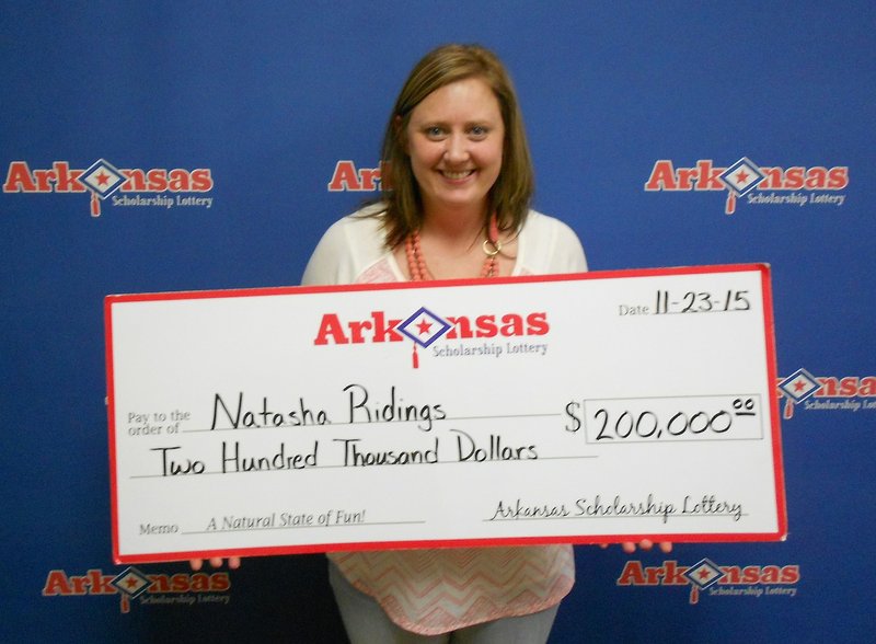 Searcy resident Natasha Ridings poses with her $200,000 check from the Arkansas Scholarship Lottery.