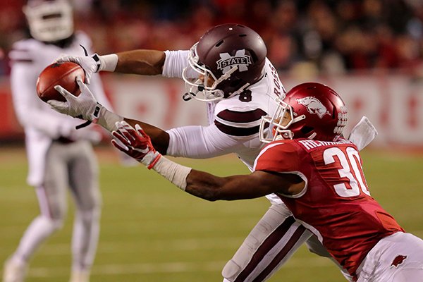 Mississippi State receiver Fred Ross catches a pass in front of Arkansas safety Kevin Richardson on Saturday, Nov. 21, 2015, at Razorback Stadium in Fayetteville. 