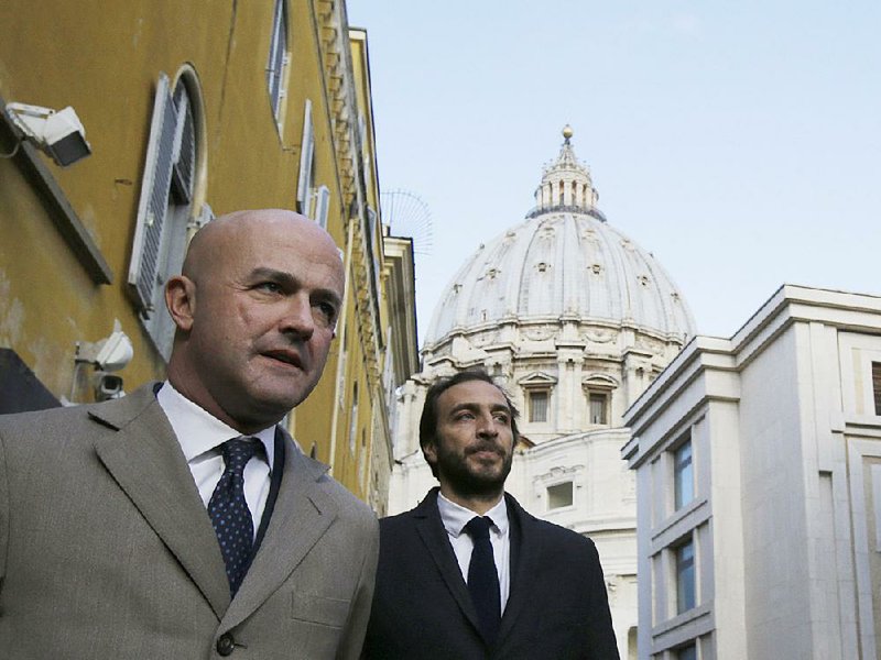 Italian journalists Gianluigi Nuzzi (left) and Emiliano Fittipaldi leave Vatican City through the Perugino gate on Tuesday.