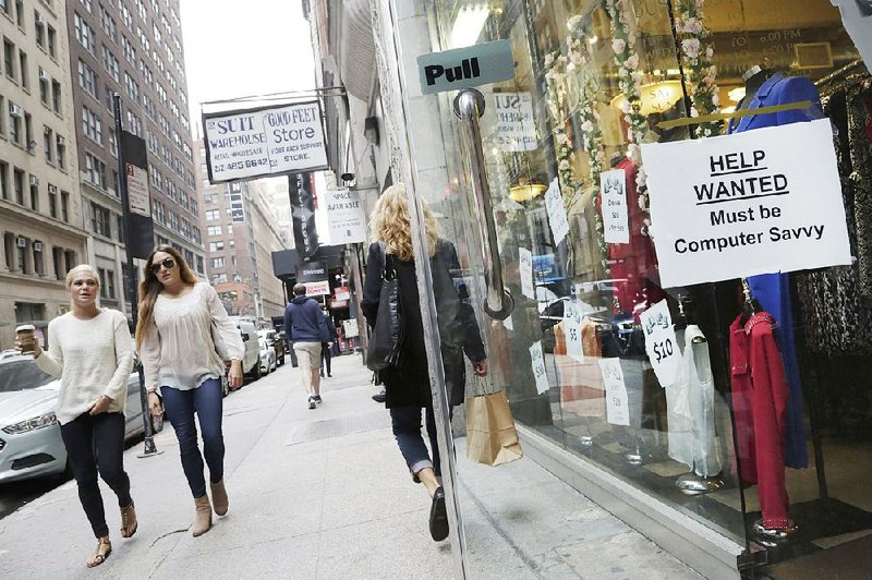 A sign announcing a job opening hangs in a store window in New York in October. Consumer confidence unexpectedly declined in November to the lowest level in more than a year as Americans grew less enthusiastic about the labor-market outlook. 