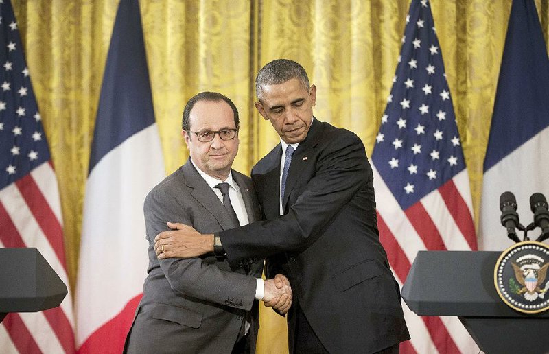 French President Francois Hollande and President Barack Obama embrace Tuesday at the White House. 