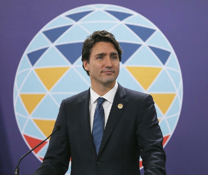 Canadian Prime Minister Justin Trudeau listens to a question during a news conference following the Asia-Pacific Economic Cooperation Summit of Leaders Thursday, Nov. 19, 2015 in Manila, Philippines. 