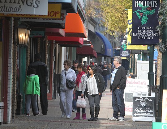 The Sentinel-Record/Richard Rasmussen Downtown shoppers: Many people were walking the sidewalks of downtown Central Avenue and shopping with local merchants Tuesday, ahead of two of the Christmas holiday's busiest shopping days, Black Friday and Small Business Saturday.