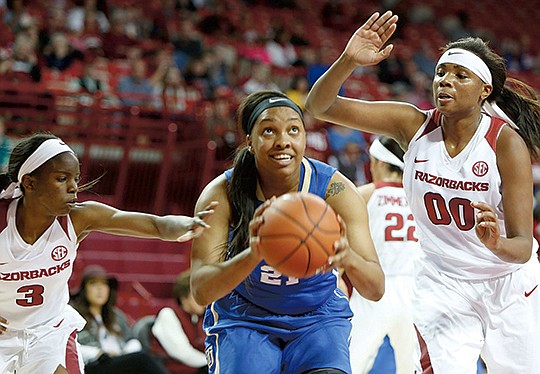 NWA Democrat-Gazette/David Gottschalk ON GUARDS: Arkansas defenders Malica Monk (3) and Jessica Jackson pressure Tulsa's Te'era Williams during the second quarter of the Golden Hurricanes' 74-67 victory Monday night at Walton Arena in Fayetteville