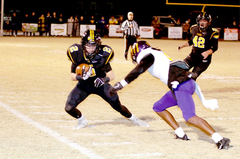 Photo by Shelley Williams Issac Disney tries to juke an Ashdown defender during Friday night&#8217;s playoff game in Prairie Grove.