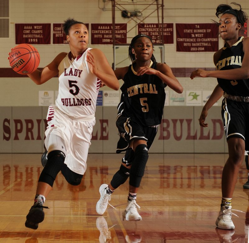 NWA Democrat-Gazette/ANDY SHUPE Kierra Lang (left) of Springdale drives past Alexsis Brown (center) and Kennedi Allen of Little Rock Central Tuesday, Nov. 24, 2015, at Bulldog Gymnasium in Springdale. Visit nwadg.com/phtoos to see more photographs from the game.