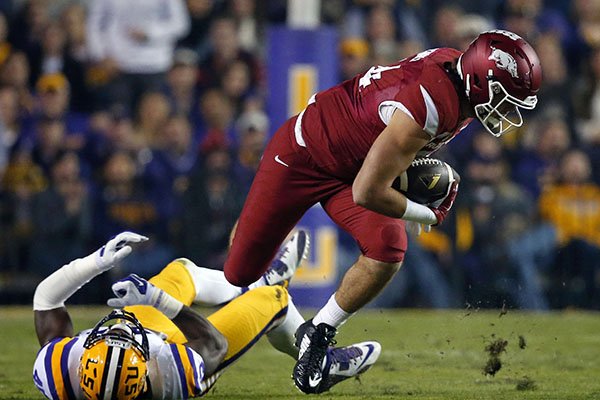 Arkansas tight end Hunter Henry is tripped up by LSU linebacker Deion Jones in the first half of an NCAA college football game in Baton Rouge, La., Saturday, Nov. 14, 2015. (AP Photo/Gerald Herbert)