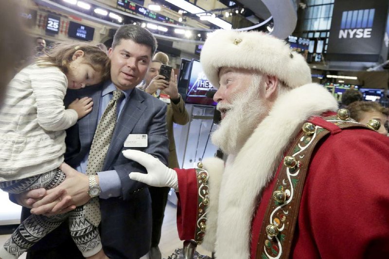 Piper Foley, 4, daughter of New York Stock Exchange Senior Vice President Douglas Foley, meets Santa Claus from the Macy’s Thanksgiving Parade, on the floor of the New York Stock Exchange on Wednesday before the opening bell. 