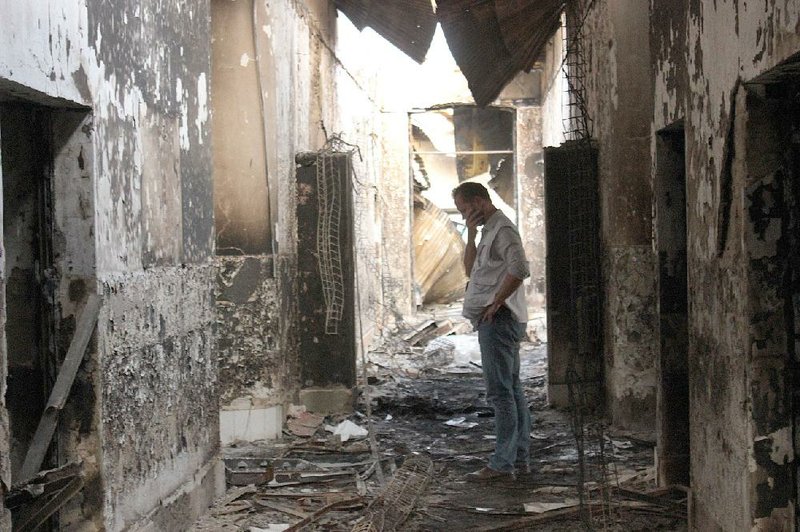 A worker with Doctors Without Borders in October looks through the charred remains of the organization’s hospital in Kunduz, Afghanistan, that was hit by a U.S. airstrike, killing dozens of civilians. The crew of an AC-130 gunship mistook the hospital for a Taliban command center 450 yards away, officials said Wednesday.