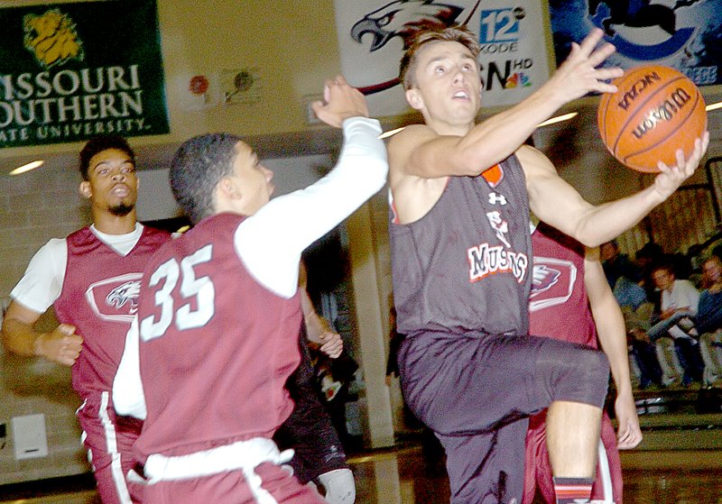 Photo by Rick Peck McDonald County&#x2019;s Max Dill drives the lane during the Mustangs 13-8 win over Joplin in the first of two six-minute periods at a jamboree held Nov. 20 at Joplin High School.