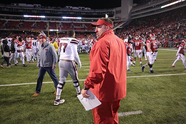 Arkansas coach Bret Bielema stands on the field following a 51-50 loss to Mississippi State on Saturday, Nov. 21, 2015, at Razorback Stadium in Fayetteville. 