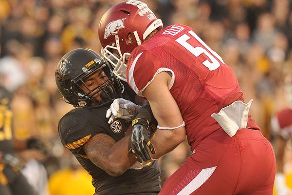 Arkansas linebacker Brooks Ellis tackles Missouri running back Marcus Murphy during a game Friday, Nov. 28, 2014, at Faurot Field in Columbia, Mo. 